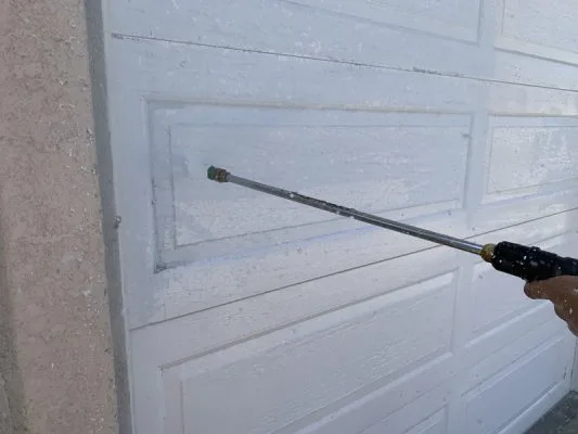 Pressure washing door before sanding