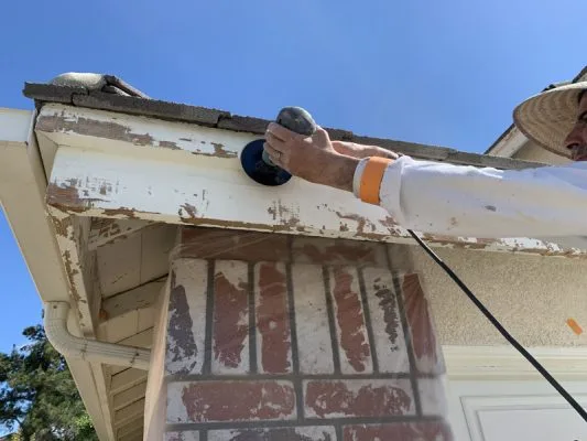 Sanding loose or flaking paint before painting fascia