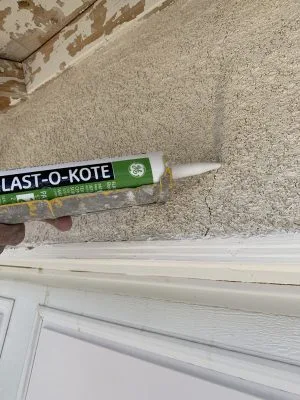 Hair stucco crack repair with elastomeric caulking